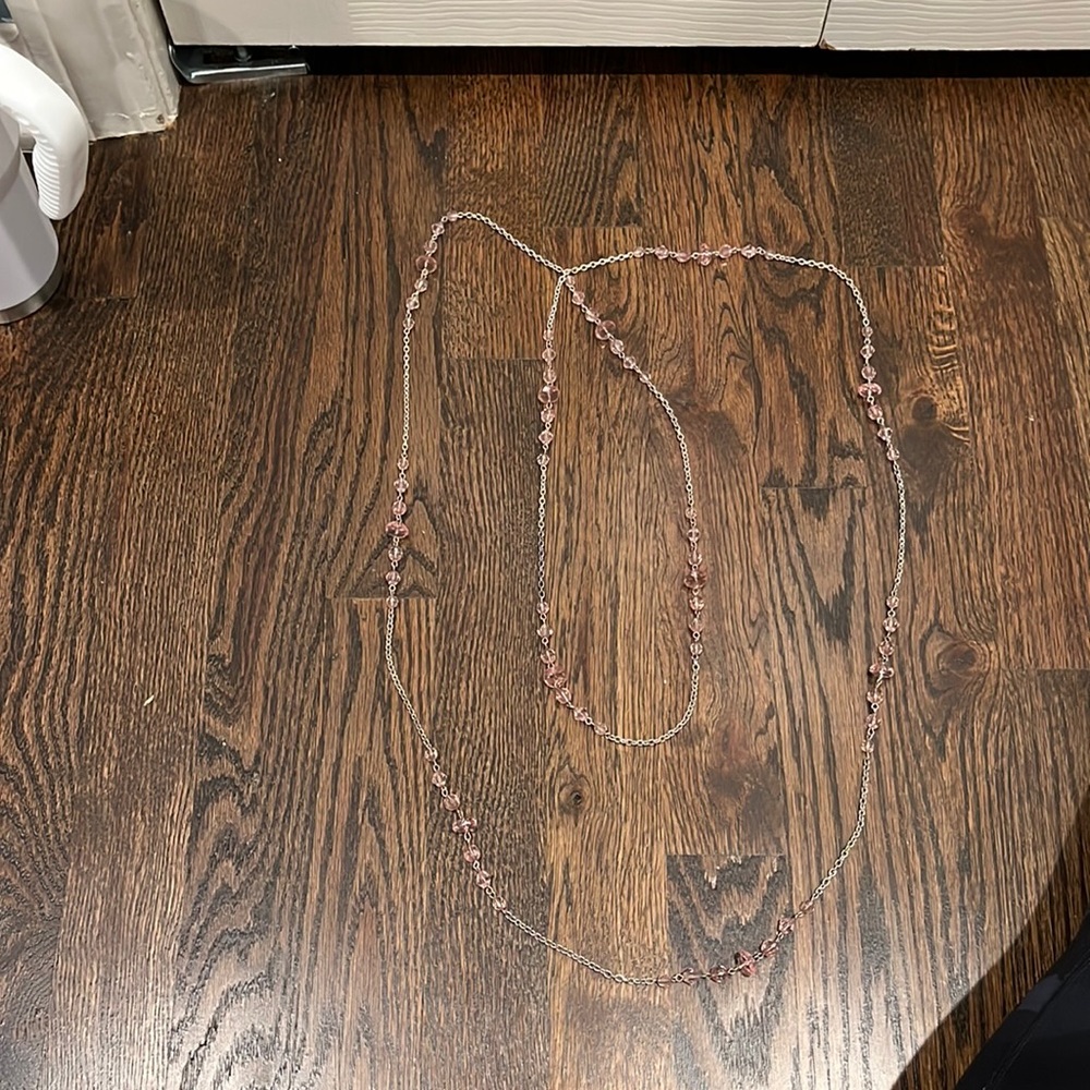 Extra long sliver necklace with pink beads.